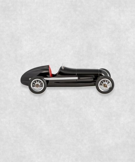 Vintage racing silberfeil car model inspired by classic Grand Prix racers and Silver Arrow legends, featuring a sleek black race car body with a striking red seat. A collectible car model for motorsport and classic car enthusiasts. Viewed from the left side.