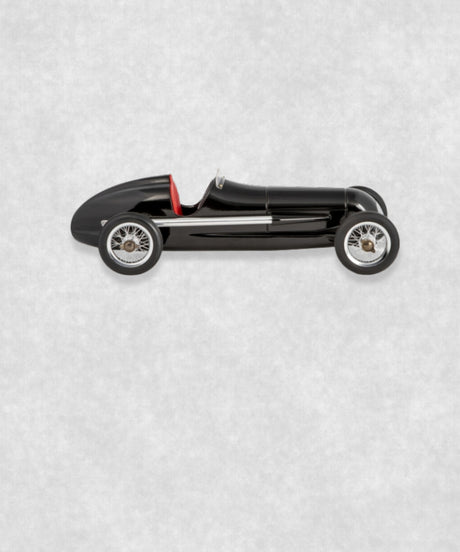 Vintage racing silberfeil car model inspired by classic Grand Prix racers and Silver Arrow legends, featuring a sleek black race car body with a striking red seat. A collectible car model for motorsport and classic car enthusiasts. Viewed from the left side.