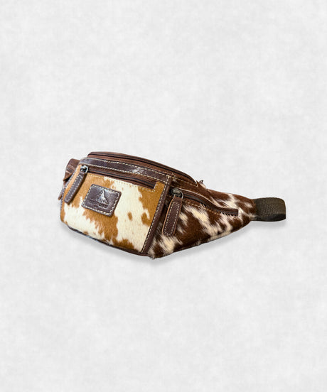 Side profile of cowhide belt bag showing adjustable strap and sleek design
