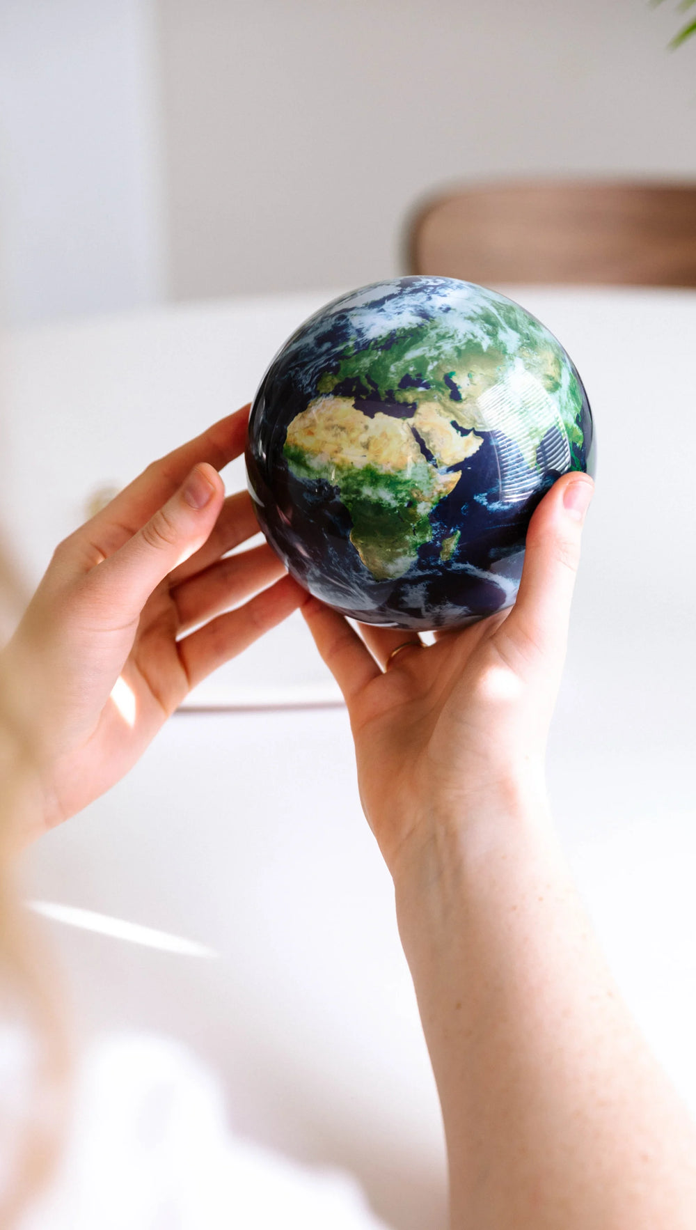 EARTH GLOBE ROTATING ON HANDS