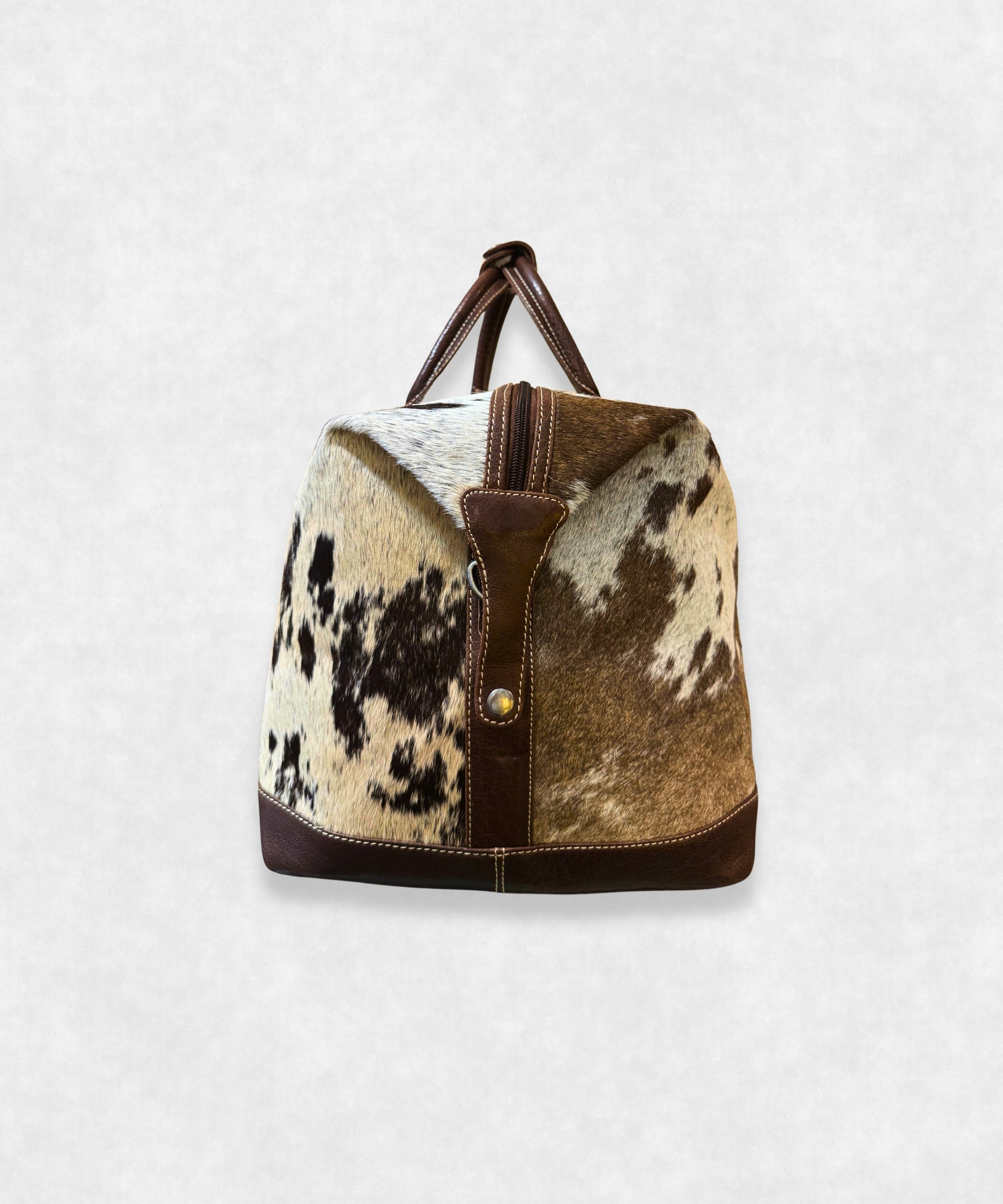 Side view of premium cowhide leather travel bag showing durable stitching and stylish profile